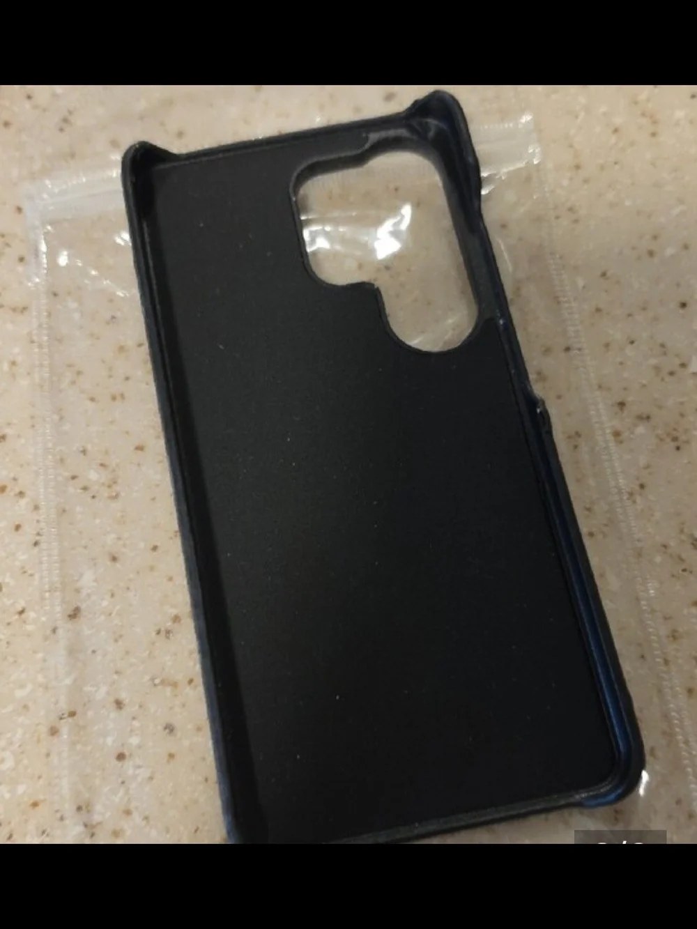 Phone Case In Black And Gray Pattern Fits an S26 Ultra Phone.